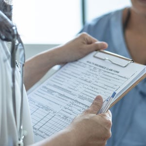 Healthcare professional reviewing medical treatment documents after an accident